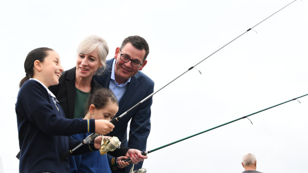 Daniel Andrews with his wife Catherine and some young fishers at Mordialloc Creek on Wednesday. 