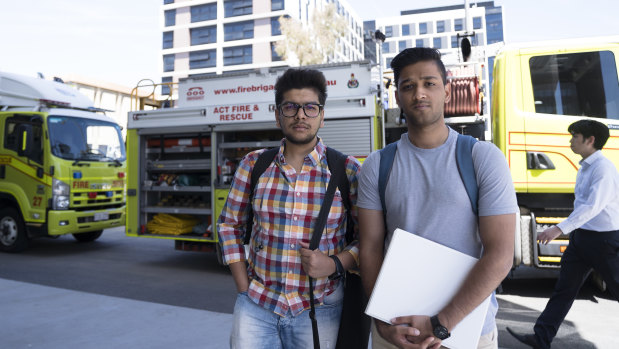 Cooper Lodge residents Aditya Jain (left) and Mudit Bhandari after they were evacuated from their residence, with police cordoning off the area