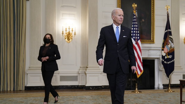 US President Joe Biden holds a face mask after speaking about efforts to combat COVID-19. Vice-President Kamala Harris is at left.