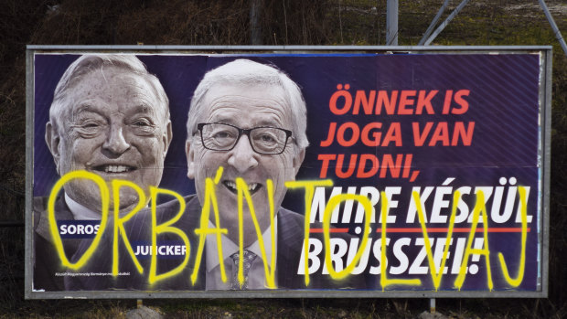 A billboard from a campaign of the Hungarian government showing EU Commission President Jean-Claude Juncker and Hungarian-American financier George Soros with the caption "You, too, have a right to know what Brussels is preparing to do." 