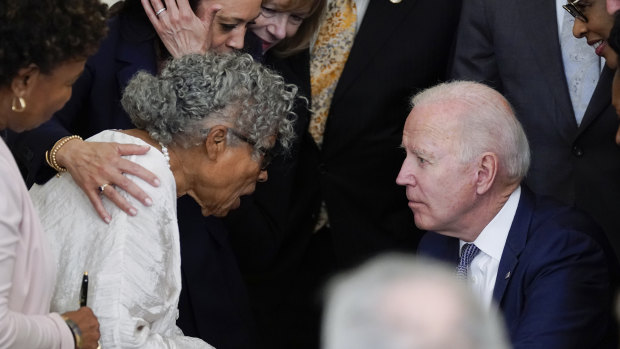 US President Joe Biden listens to 94-year-old activist Opal Lee after signing the Jbill. 