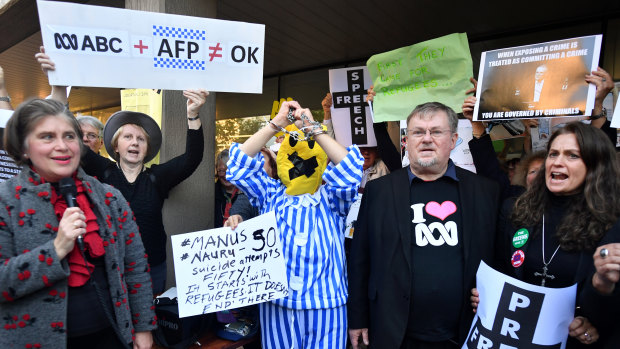 Protestors hold placards during a protest rally calling for the protection of press freedom outside the office of Communications Minister Paul Fletcher 