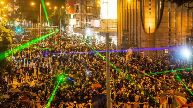 Pro-democracy protesters shine laser pointers during a clash at Admiralty district in Hong Kong on August 31.