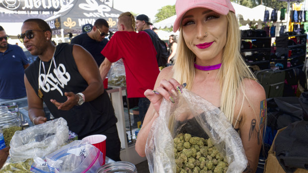 A bud tender offers attendees the latest products of cannabis at the High Times 420 SoCal Cannabis Cup in San Bernardino, California earlier this month.