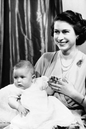 Prince Charles of Edinburgh (now King Charles III), sits for a photo with his mother, then Princess Elizabeth in Buckingham Palace in 1949.