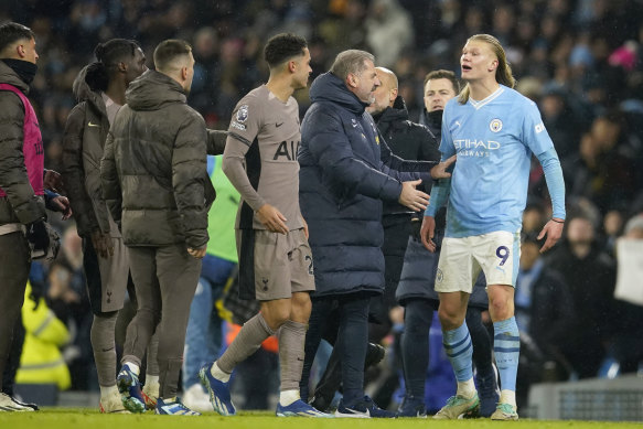 Ange Postecoglou holds back an angry Erling Haaland at the end of the match.