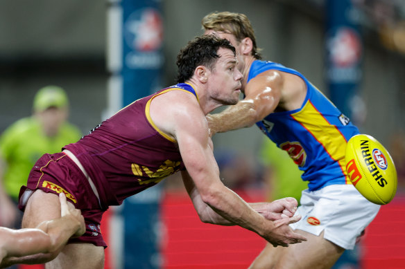 Lachie Neale gets a handball away.