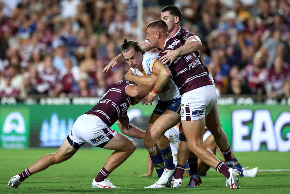 Eel's fullback Clint Gutherson gets wrapped up by the Sea Eagles defense.