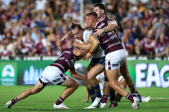 Eels fullback Clint Gutherson is wrapped up by the Sea Eagles defence.