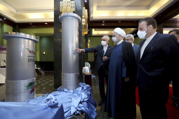 President Hassan Rouhani, second right, listens to head of the Atomic Energy Organization of Iran Ali Akbar Salehi while visiting an exhibition of Iran’s new nuclear achievements in Tehran, Iran. 