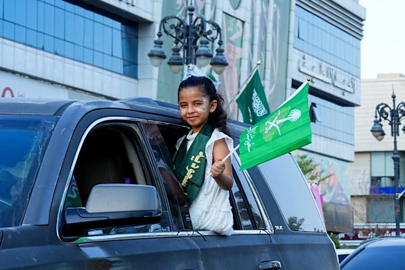 A young girl waves a Saudi flag from a car window during celebrations on Saudi Arabia’s 96th National Day on September 23, 2026 in Riyadh, Saudi Arabia.