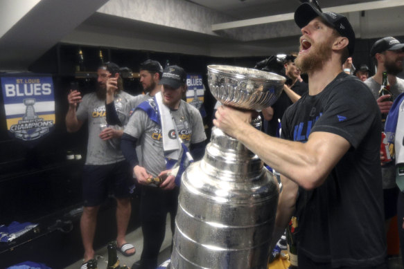 St Louis Blues' Carl Gunnarsson celebrates with the Stanley Cup in the locker room after defeating the Boston Bruins in game seven last year.