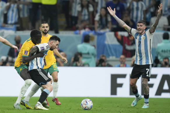 Australia’s Garang Kuol, left, and Argentina’s Lionel Messi.
