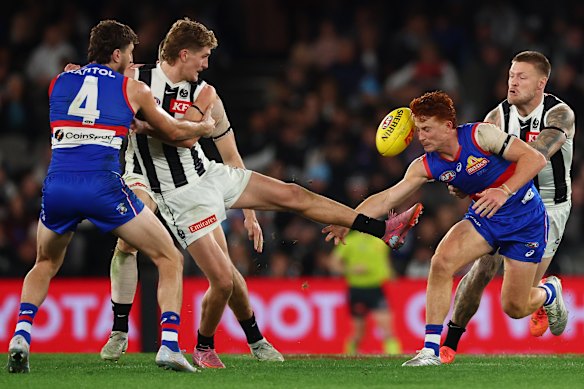 Ed Allan gets a kick away under pressure.