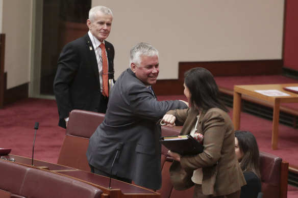 Senator Rex Patrick elbow taps Concetta Fierravanti-Wells after she voted with the crossbench during an attempt to establish an inquiry into Australia's relationship with China.