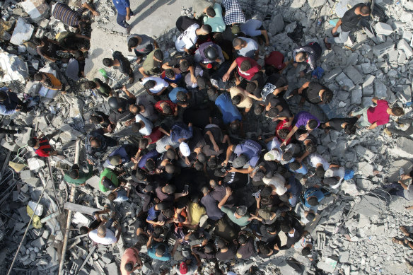 Palestinians look for survivors of the Israeli bombardment in the Maghazi refugee camp in the Gaza Strip.