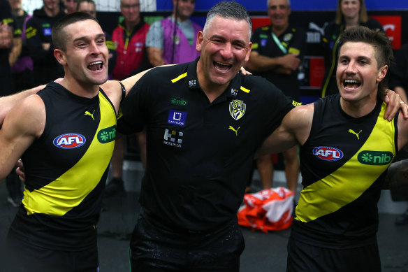 Adem Yze celebrates his first win as  Richmond coach with Jayden Short and Liam Baker under his arms.