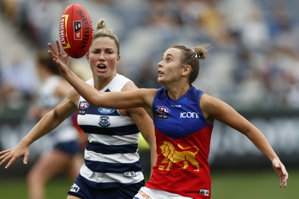 Gabby Collingwood of the Lions gathers the ball in front of Melissa Hickey of Geelong.