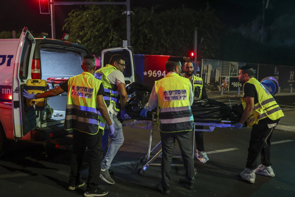 A dead person is loaded into an ambulance following a shooting attack in Jaffa, a mixed Arab-Jewish area of Tel Aviv on October 1.