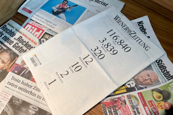 “320 years, 12 presidents, 10 emperors, 2 republics, 1 newspaper” reads the last front page of the Wiener Zeitung, which is on top of other daily newspapers. 