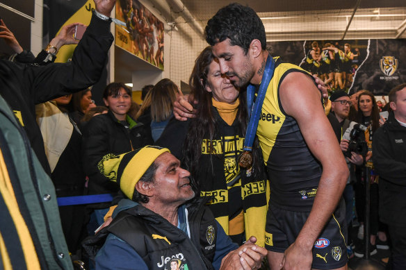 Marlion Pickett celebrates in the Richmond rooms with mother Angela and father Thomas. 