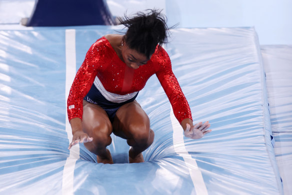 Simone Biles stumbles upon landing in the women’s team final on Tuesday night.