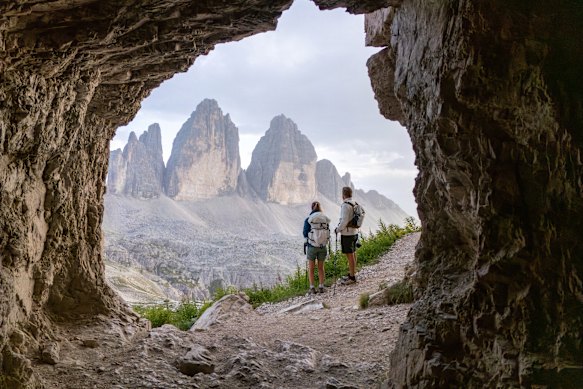 A cave frames a Dolomites view.