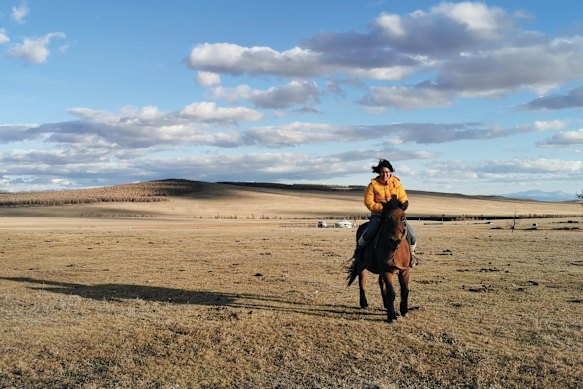 Lonely Planet editor Fabienne Fong Yan  practises her horseback-riding
skills on the  Mongolian plains.