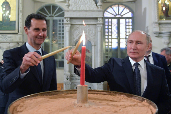 Bashar al-Assad (left) and Putin light candles at an Orthodox cathedral in Damascus in January 2020.