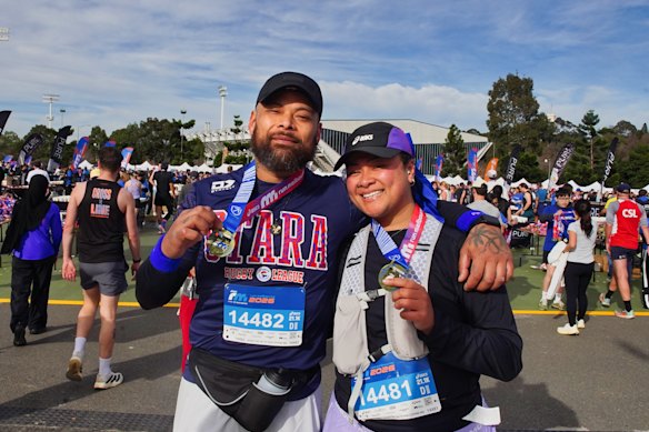Tuitiga Leota and her sister Grace celebrate at the finish line after completing the half marathon.