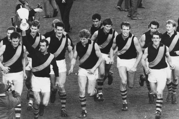 Led by captain Fred Swift, the victorious Richmond team runs a lap of honour after winning the 1967 premiership. 