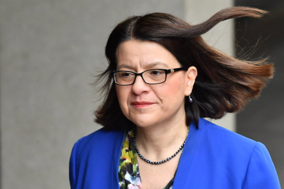 Victorian Health Minister Jenny Mikakos walks into the government's COVID-19 media conference on Friday.