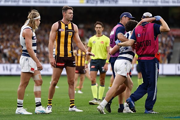 Heavy hit: Miers was helped from the field as Nash watched on.