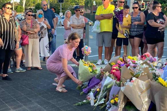 Mourners paying their respect at the site of the crash on Wednesday night.