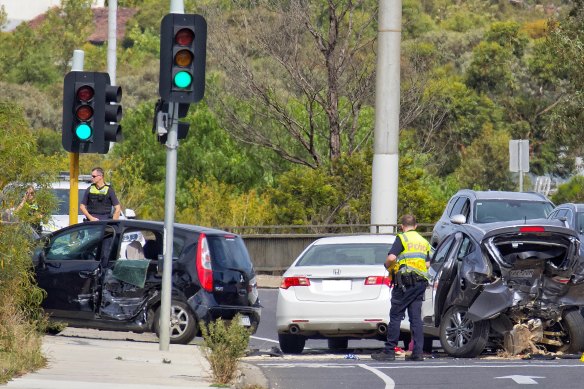 Police attend to the four car collision on the Chandler Hwy in Kew on Sunday.  