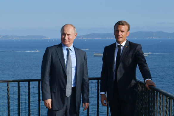 French President Emmanuel Macron, right, and Russian President Vladimir Putin pose for a photo during their meeting at the fort of Bregancon in Bormes-les-Mimosas, southern France in 2019.