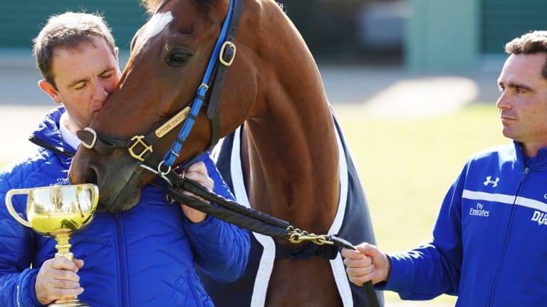 The day after: Charlie Appleby (left) and strapper Tash Eaton of team Godolphin pose with Cross Counter.