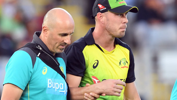 Chris Lynn is helped from the field after dislocating his shoulder.