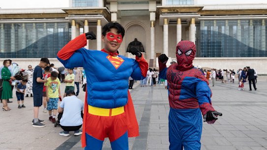 Children wear superhero costumes in front of the Government Palace in Ulanbaataar.