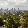 A view of leafy Holland Park, with Brisbane’s CBD skyline in the background.