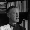 English author Ian Fleming (1908-1964) in his study with one of the series of James Bond novels that he wrote. 