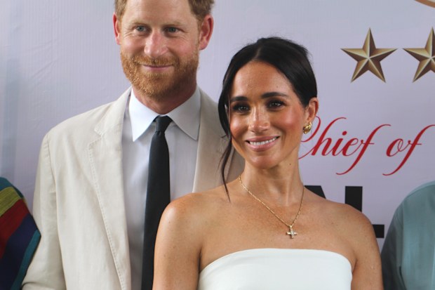 Britain's Prince Harry, Duke of Sussex, and Britain's Meghan, Duchess of Sussex, pose for a photo as they attend the program held in the Armed Forces Complex in Abuja, Nigeria on May 11, 2024.