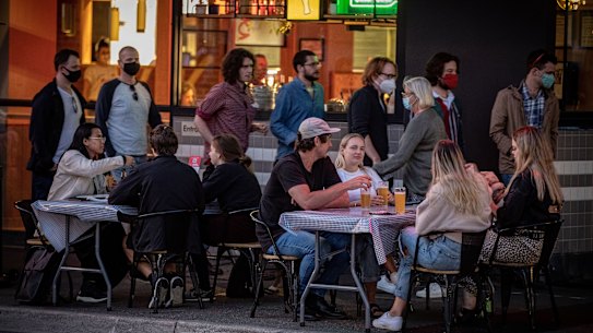 Outdoor dining in Melbourne's east on Wednesday night. Groups of customers are limited to 10 people and must be seated 1.5 metres from other tables.