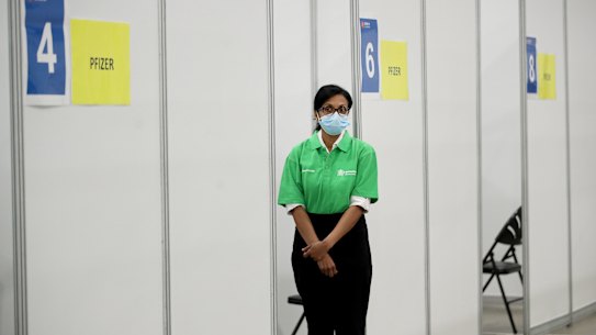 BRISBANE, AUSTRALIA - AUGUST 11: Staff work at a vaccination hub at Brisbane Convention & Exhibition Centre on August 11, 2021 in Brisbane, Australia. The vaccination hub will provide the Pfizer vaccine and second dose of AstraZeneca to individuals with bookings as Queensland opens the vaccine registration list state-wide to anyone over 16. The Australian government says 70% of eligible Australians must be fully vaccinated before the country reopens. (Photo by Jono Searle/Getty Images)