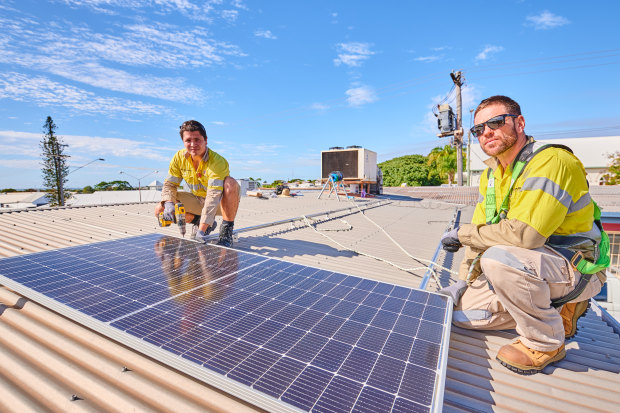 Gas plant electricians Ciaran Fallon and Tom Willis at their side project installing rooftop solar. 