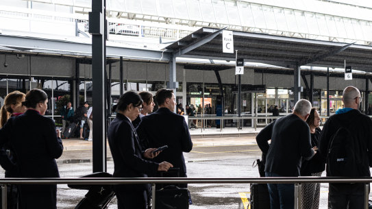 Passengers wait for Ubers at the new Uber rank at the International Terminal. 