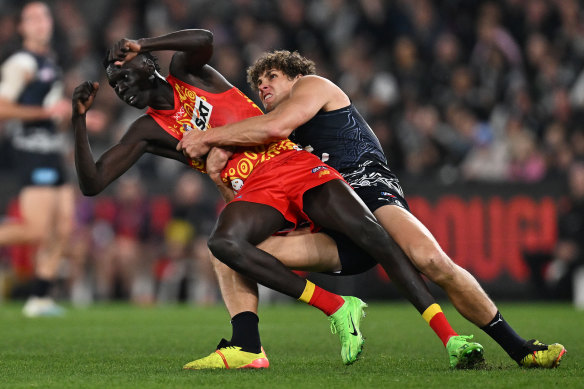 Mac Andrew is tackled by Carlton’s Charlie Curnow. Damien Hardwick pointed to another contest between the duo.