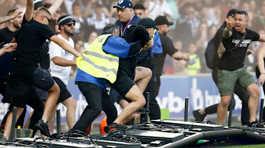 Fans storm the field.