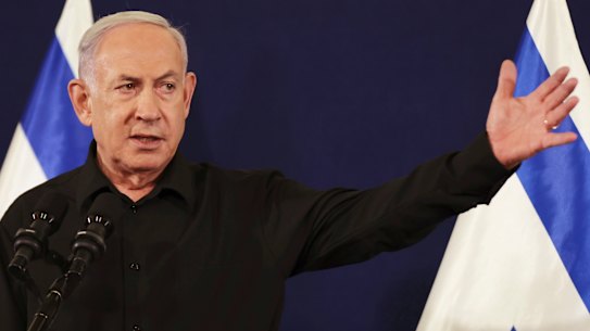 Israeli Prime Minister Benjamin Netanyahu speaks during a press conference with Defense Minister Yoav Gallant and Cabinet Minister Benny Gantz in the Kirya military base in Tel Aviv, Israel, Saturday, Oct. 28, 2023. (Abir Sultan/Pool Photo via AP)