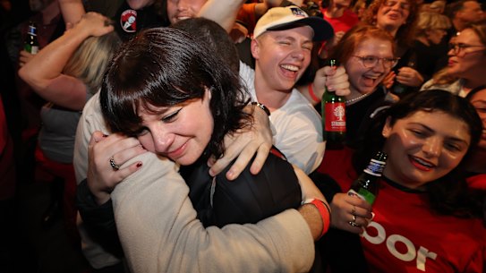 Embracing the moment: Labor supporters could tell where things were headed on Saturday night.